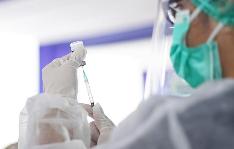 Scientist preparing a vaccine dose in a medical laboratory