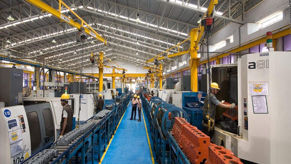 Industrial manufacturing production line with machinery and workers, used as an illustrative image for India's industrial output report