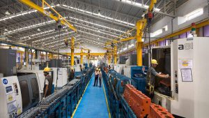 Industrial manufacturing production line with machinery and workers, used as an illustrative image for India's industrial output report